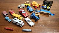 Full lot overview including vintage toy cars, wooden pull car, metal Tootsie Toy boats, and box of marbles.