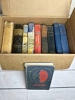 Box of 9 hardcover books showing titles and spines with signs of age and wear.