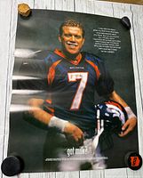 Full body image of John Elway wearing Broncos jersey, holding helmet, 'got milk?' text visible