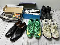 Lot of five pairs of men's shoes showing condition and styles: Nike Kyrie, Superman Converse, The North Face boots, dress shoes, and athletic sneakers.
