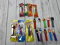 Lot of 14 vintage PEZ dispensers including packaged and loose units with various character heads