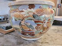 Side view showing hand painted Japanese men in traditional dress with detailed patterns and colors.