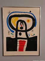 Full view of the framed lithograph showing the colorful abstract artwork and Joan Miro signature.