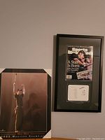 Framed Sports Illustrated cover and signed plaque displayed on wall.