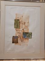 Full view of the framed embossed etching artwork titled 'Golden Fossils' featuring layered rectangular shapes in muted tones with colored embossed sections.