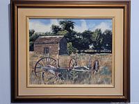 Full view of the oil painting framed, depicting an abandoned wagon in front of a wooden barn and trees.