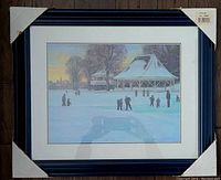 Framed print of a winter twilight park scene with people skating around a gazebo, dark blue frame with protective corner cardboard.
