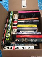 Box containing 16 books including Guinness World Records 2009, books by Rick Mercer, Adele Parks, Janie Chang, Joseph Boyden, Fiona Barton, Lisa Jewell, Philippa Gregory, Kathy Reichs among others.