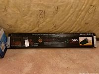 Box of Drop & Done vinyl plank flooring showing original sealed packaging with fibreglass core vinyl planks.