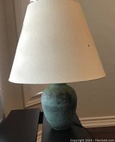 Front view of the table lamp showing full lamp with shade and base.