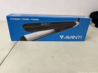 Box of Avanti professional flat iron showing titanium plates and heating temperature.