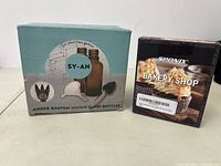 Box of amber Boston round glass bottles with associated droppers and rubber bulbs.