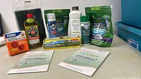 Full lot of assorted new household cleaning supplies, showing products front and center on a table.