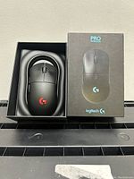 Photo of Logitech G Pro Wireless mouse inside open box with packaging next to it.