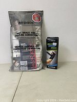 Potensco Back Brace and Posture Corrector Size S/M in sealed packaging alongside Zateria Wrist Support Right L/XL in box