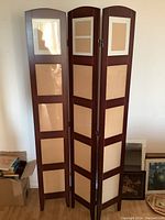 Front view of the three-panel wooden folding picture screen showing the picture display slots with glass inserts and the wood finish.