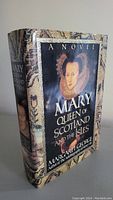 Front cover of the hardcover novel 'Mary Queen of Scotland and the Isles' by Margaret George showing book title and textured jacket design.