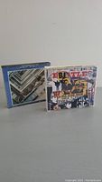 Two Beatles CDs side by side, one with "The Beatles 1962-1966" cover art and the other with a collage style cover featuring the band's name and images