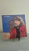 Front cover of Willie Nelson The Psalms LP showing artist portrait with headband and red jacket.