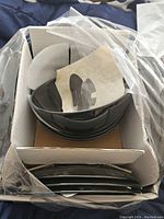 New packaged black plates and bowls in protective cardboard and plastic packaging