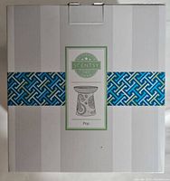 Original retail box showing Scentsy logo and 'Pop' model name on the front with decorative blue geometric band.