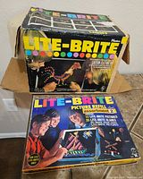 Original Lite-Brite box showing colorful logo and images of children playing. Box has wear and tear, some damage visible.