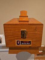 Front view of the wooden Esquire Shoe Care Chest, showing the latch and Esquire label.