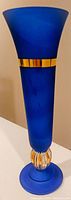 Full view of the cobalt blue vase showing the gold gilt band at the top and the flared opening.