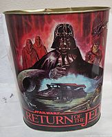 Front panel of metal trash can featuring Darth Vader, Imperial Royal Guards, Star Wars ships and characters, with Return of the Jedi title.