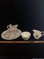 Old Foley handled floral plate, Duchess sugar bowl and creamer, and Old Foley creamer jug displayed with measuring scale for size reference.