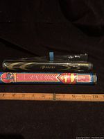 Both golf putter grips side by side with measuring tape showing about 10 inches length