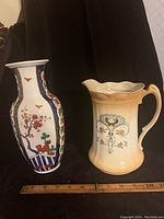 Photo showing both Japanese porcelain vase and antique water pitcher side by side with ruler beneath for scale