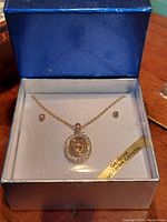 Full set in original blue box with satin lining, showing pendant necklace and two stud earrings with genuine Austrian crystals.