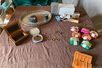 Full view of lot including vintage vanity tray, trinket boxes, wooden jewelry box, compact mirror, earrings, rings, and soaps