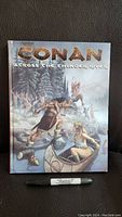 Front cover of Conan RPG sourcebook with title and action scene illustration.