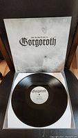 Front cover and vinyl record showing the Gorgoroth logo and album title in black text on white background.