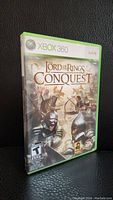 Front cover of Xbox 360 game case showing Lord Of The Rings Conquest artwork and branding.
