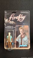 Front view of sealed Hoban Washburne Firefly action figure with character and logo visible.