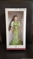 Front view of sealed Barbie Gemini doll in original box with green gown visible.
