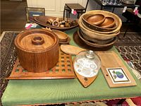 Overview photo of Dansk teak ice bucket, multiple wooden bowls, trays, nutcracker, napkin rings, cheese dome, and cheese board.