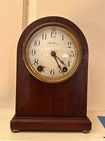 Front view of Seth Thomas mantel clock showing dial, hands, winding holes, and brand name.