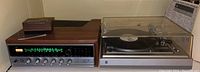 Sansui tuner and Dual turntable side by side on shelf