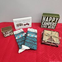 Photo showing all items: two camping signs, a pair of camping socks, and two sets of coasters.