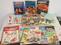 Photo showing 11 vintage science books laid out, featuring topics including dinosaurs, chemistry, sports, animals, and geography.