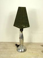 Full view of vintage cast aluminum table lamp with green beaded square tapered shade, showing the whole lamp including the base and shade.