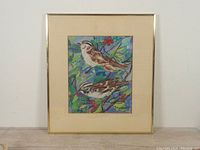 Full view of the framed bird painting showing gold-tone frame and cream mat
