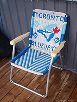 Front angle of the vintage Toronto Blue Jays folding lawn chair showing woven fabric with logo and aluminum frame