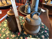 Copper tea kettle with rounded body, handle on top, curved spout.