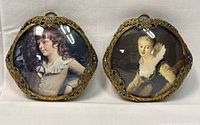Both antique brass filigree wall framed prints shown upright with convex glass that covers the portraits. A young boy and young girl depicted in the prints.