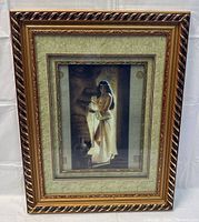 Full view of framed art print with ornate gold and brown twisted rope frame and green textured matting.
